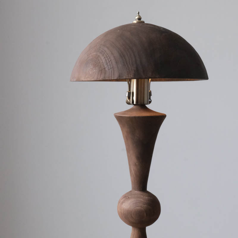 An antique solid wood table lamp