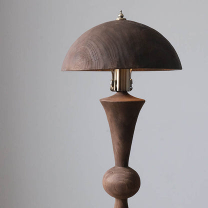 An antique solid wood table lamp