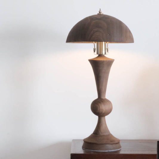 An antique solid wood table lamp
