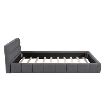 A double bed with a backrest made of soft linen