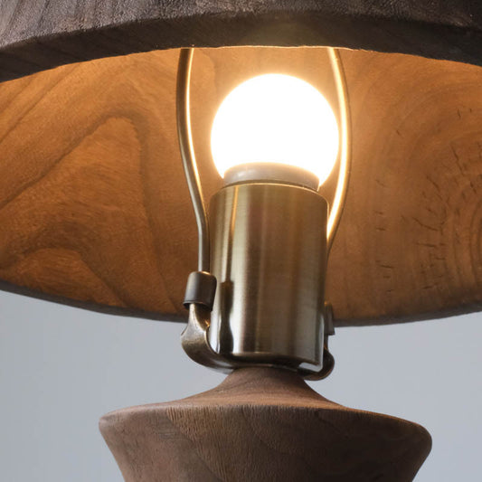 An antique solid wood table lamp
