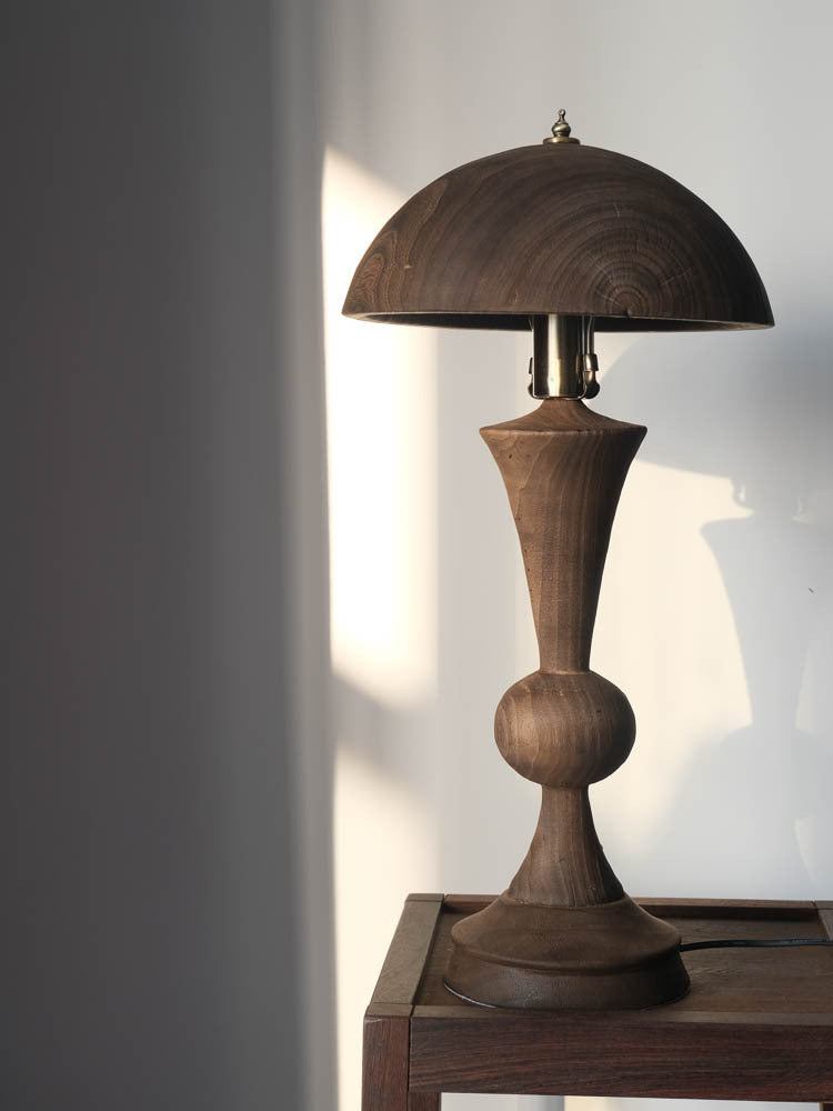 An antique solid wood table lamp